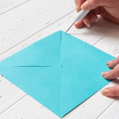 Colorful scrapbook paper with a paper piercer at one corner.