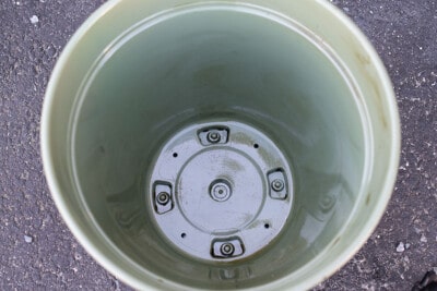 Top down view of plant pot inside with oil smeared on it for a mold.