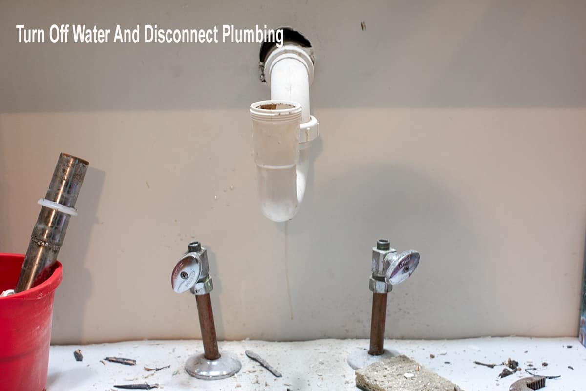Replacing a faucet by disconnecting plumbing.