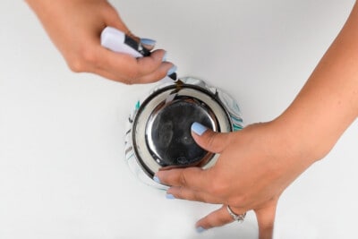 Tracing around a polymer clay coaster with a knife.