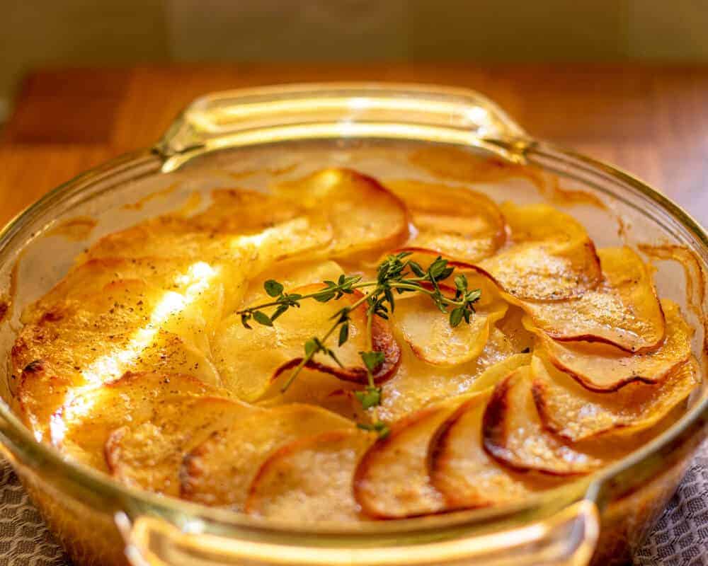 Potato Boulangere in a dish on a table.