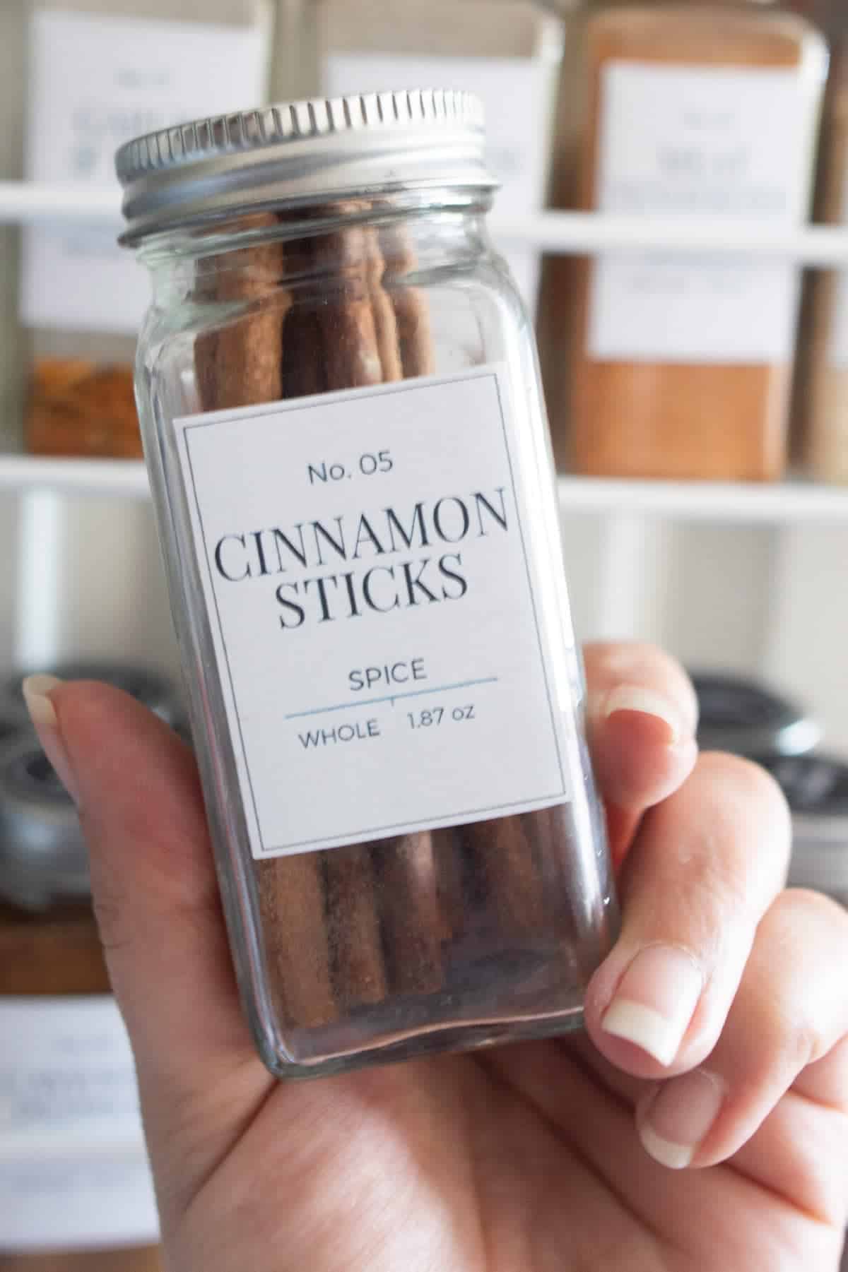 Spice jar with printable label being held up.