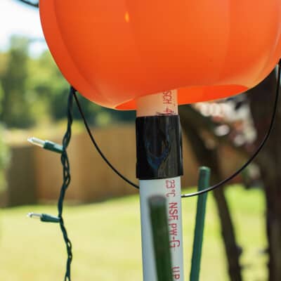 A marked pvc pipe with duct tape wrapped around it at the marking.