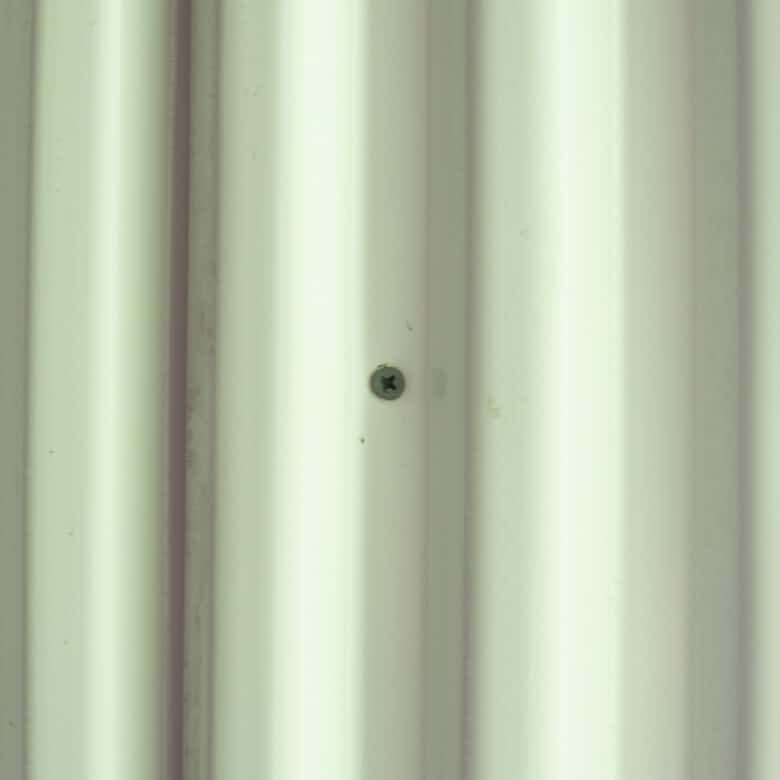 Screw placement in hills of pvc corrugated board.