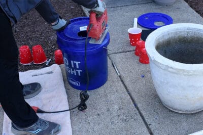 Cutting the lid on a 5 gallon bucket with a jig saw.