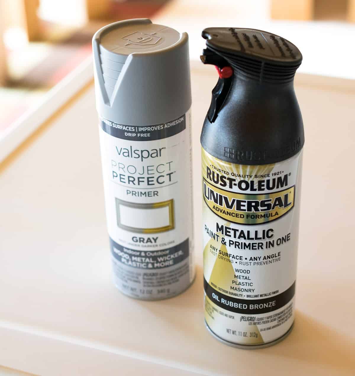 Rustoleum metallic rubbed broze and Valspar primer in gray in top of mini refrigerator.