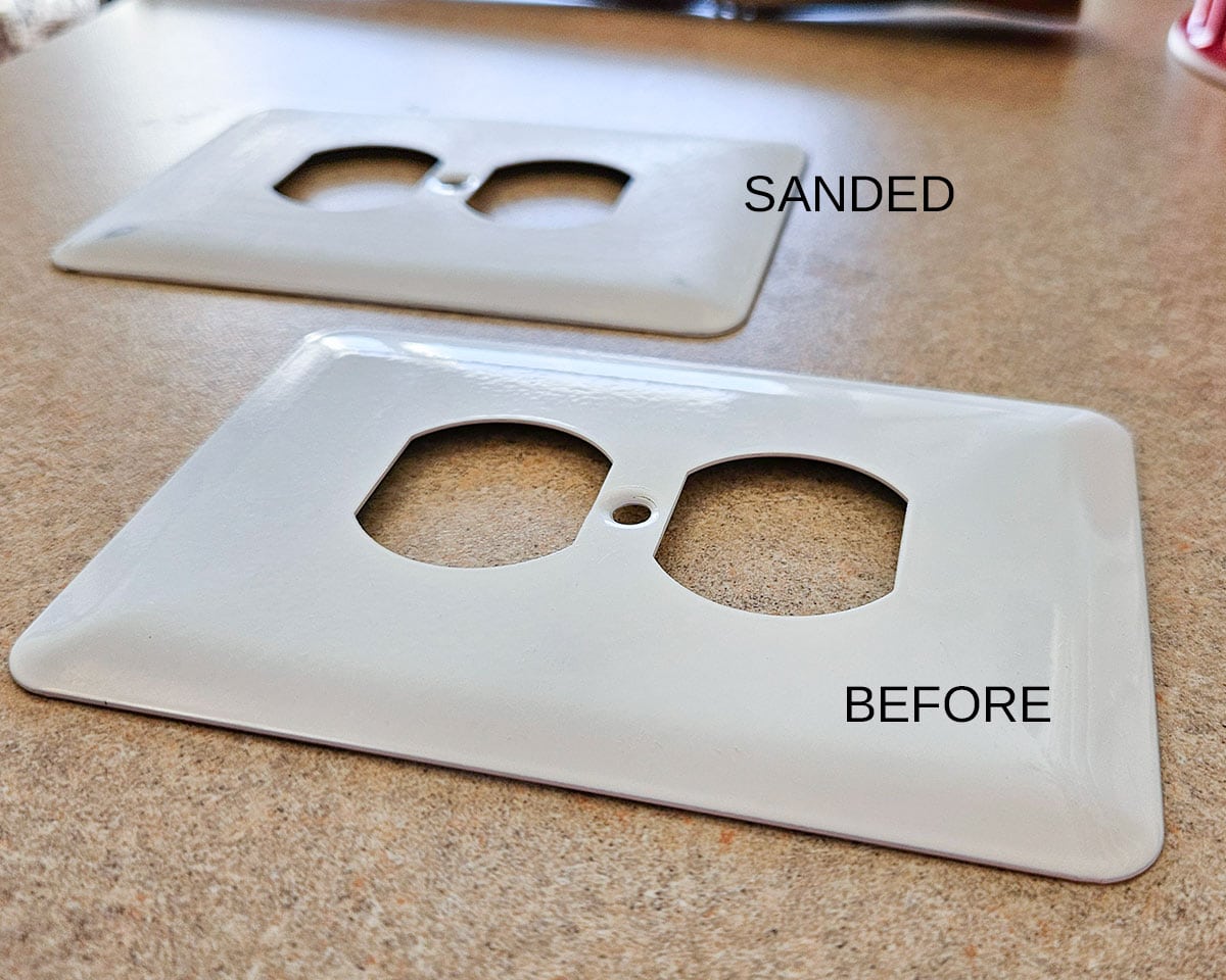 Two outlet covers showing how well to sand them and prep for painting.