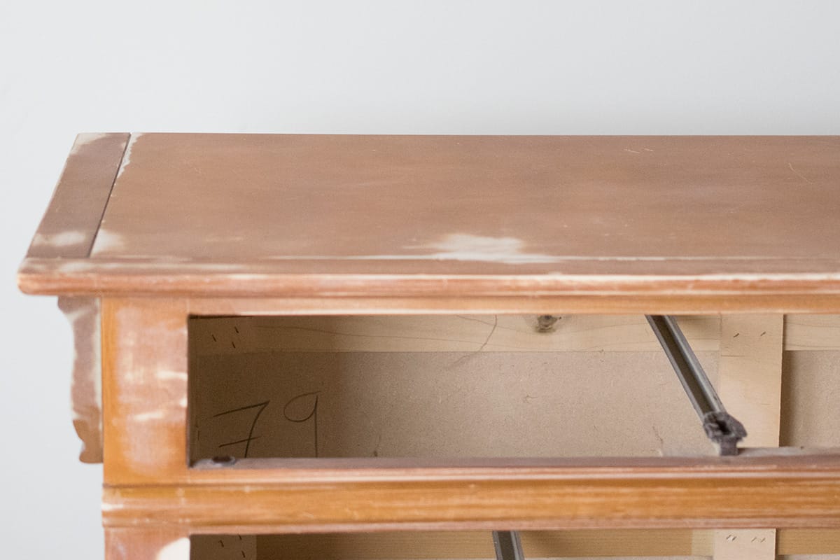 A sanded dresser that is prepped for painting with drawer missing.