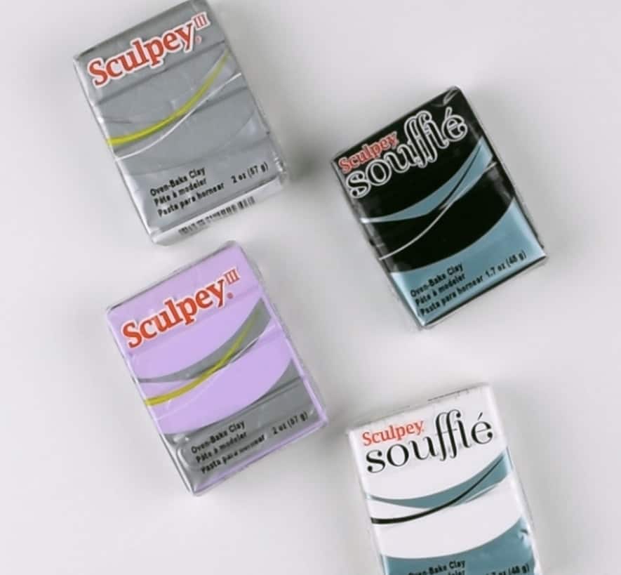 Packs of Sculpey polymer clay on a white background.