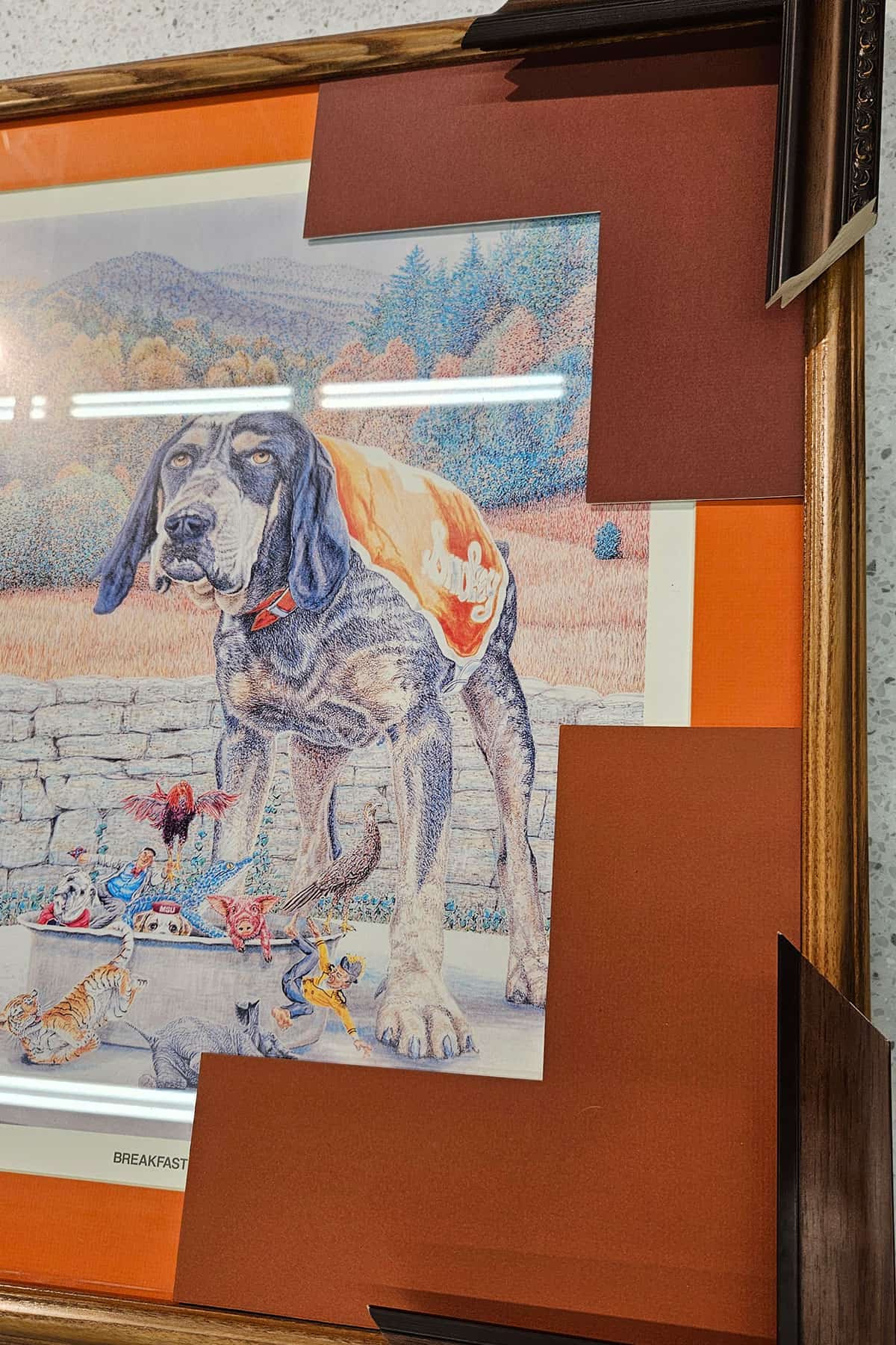 A framed print of Smokey mascot being matted and framed.