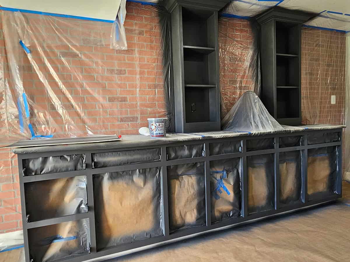 Cabinets being masked and spray painted in progress,
