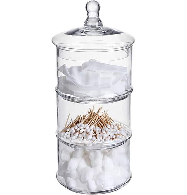 Stacked glass containers with cotton swabs, q-tips, and cotton pads in them.