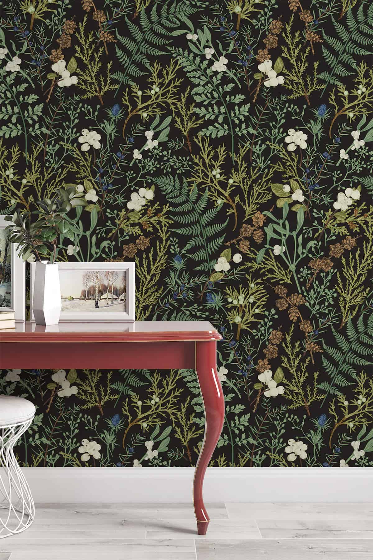 Bold moody botanical wallpaper with a desk and stool.