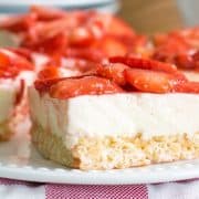 Strawberry cheesecake on top of a rice krispie crust closeup.