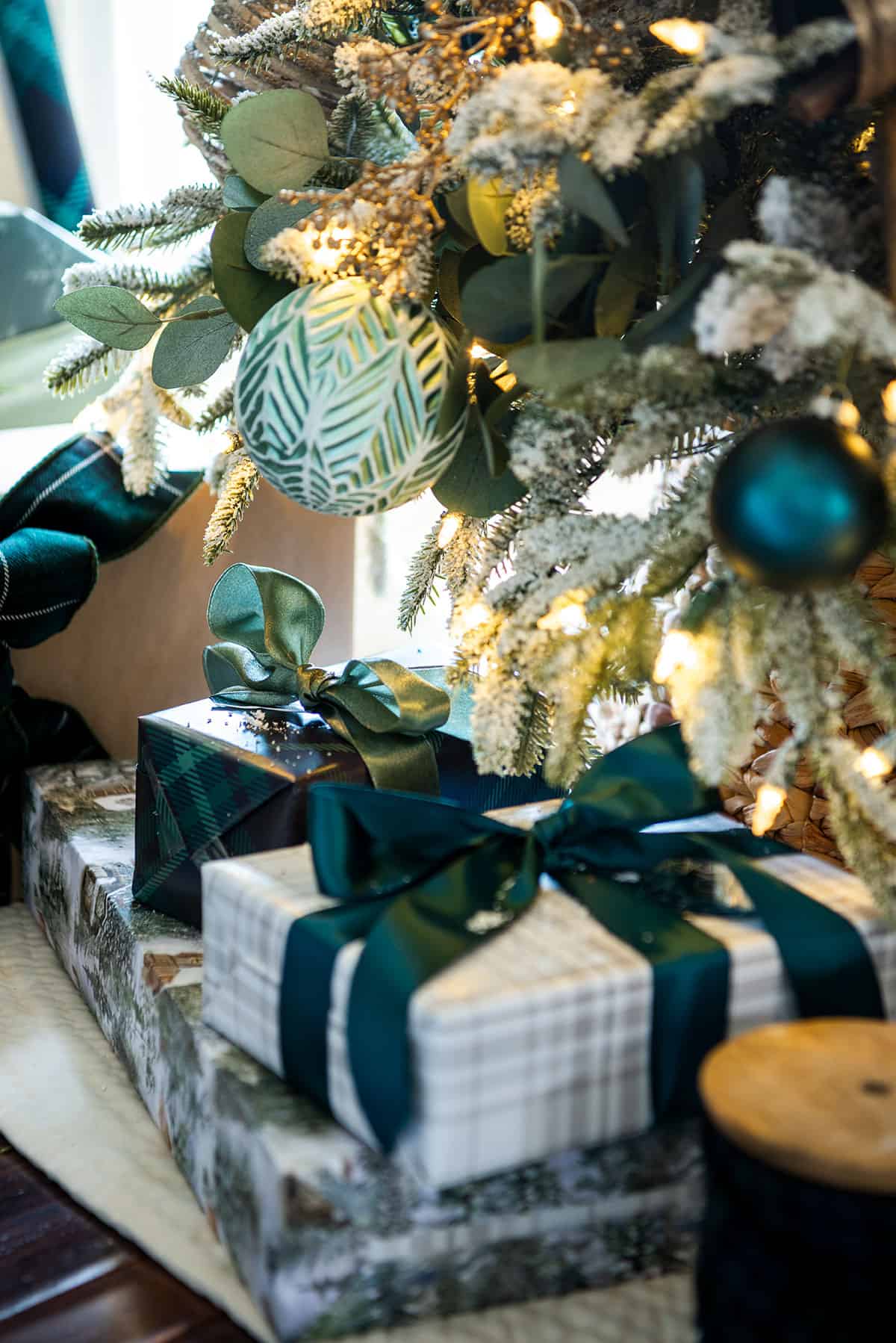 Hunter green wrapped gifts with sage green and hunter green ribbon.
