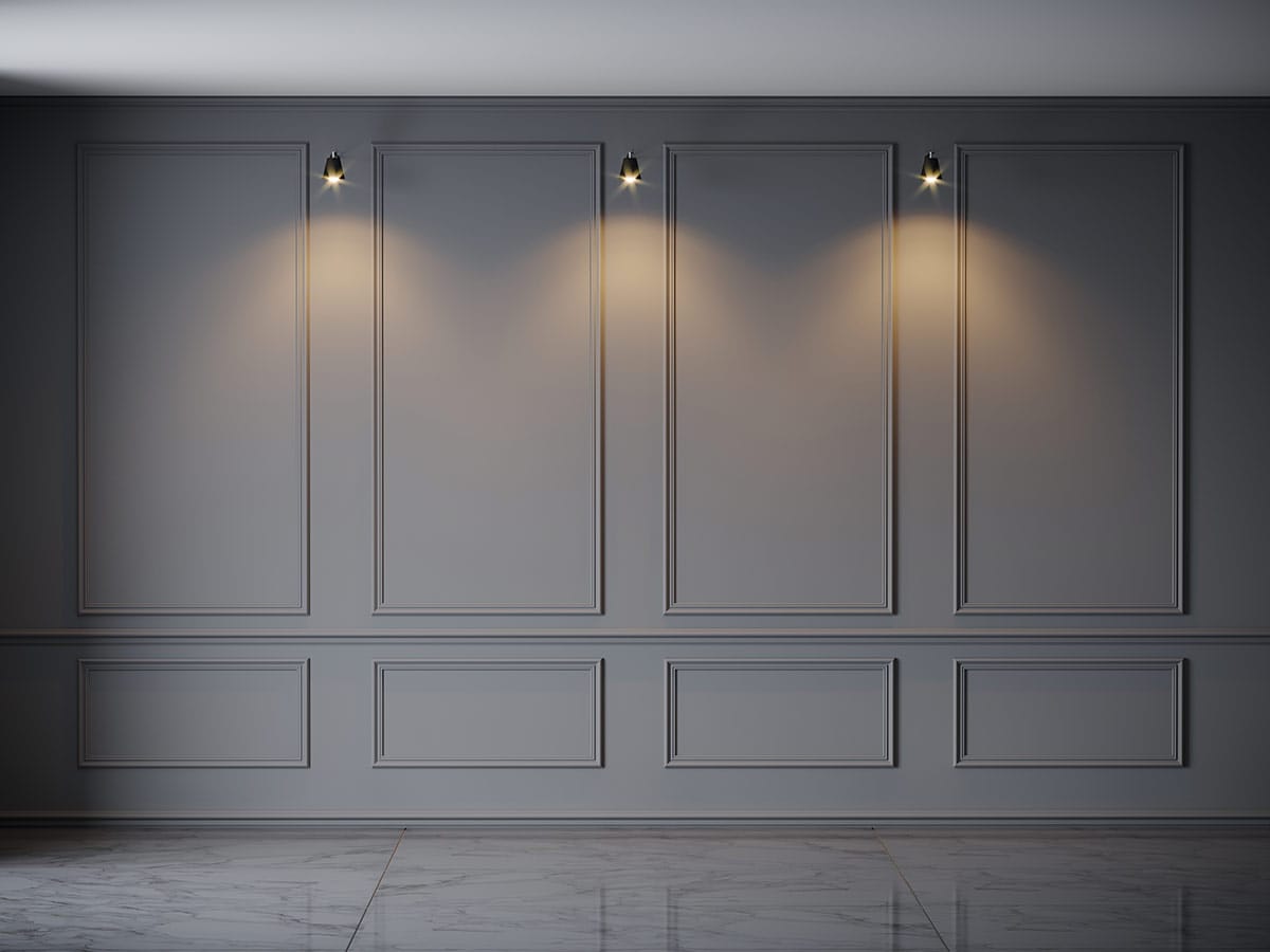 Crisp feature wall design features floor to ceiling rectangle wainscoting panels and chair rail.