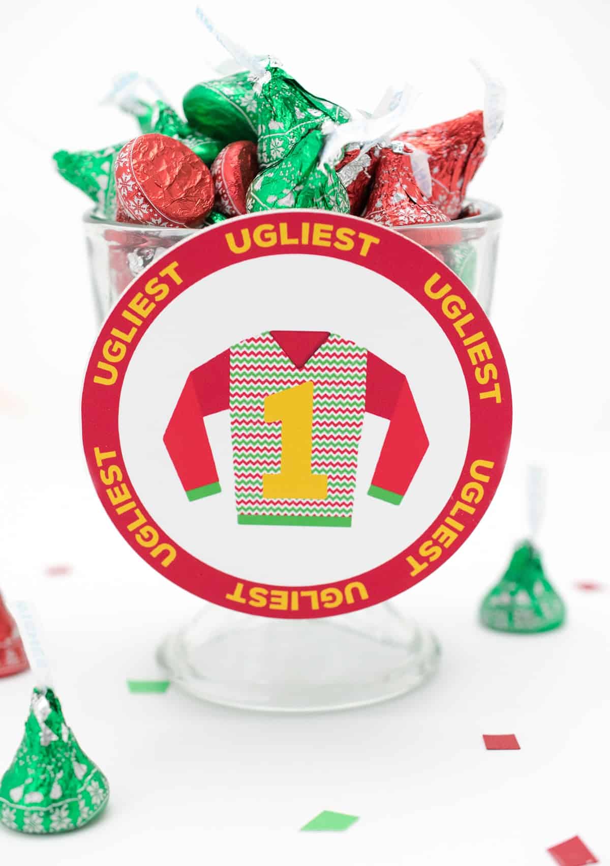 Ugly Christmas sweater free printable attached on glass mini trifle bowl of Hershey's kisses.