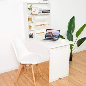 Wall Mounted Folding desk laid out with supplies on it.