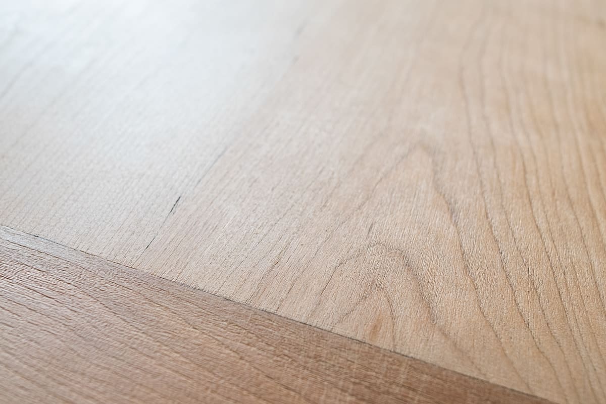 Closeup of stripped dining room table wood grain.